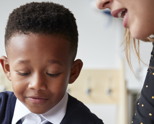 Boy in classroom being mentored